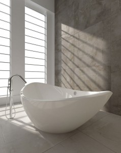 A curvy freestanding tub flanked by natural light creates a seductive sanctuary 